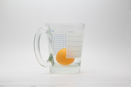 A table tennis ball and a glassの写真素材