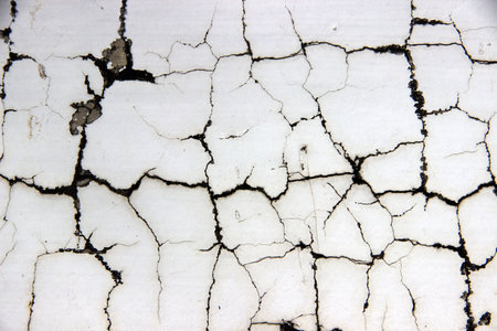 White cement walls, old, dirty and cracked surfaces.