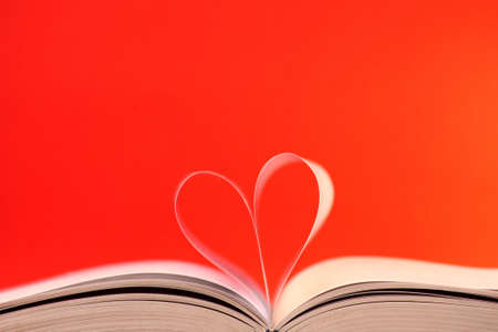 Pages of a book curved into a heart shapeの写真素材