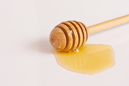 Honey with wood dipperの写真素材
