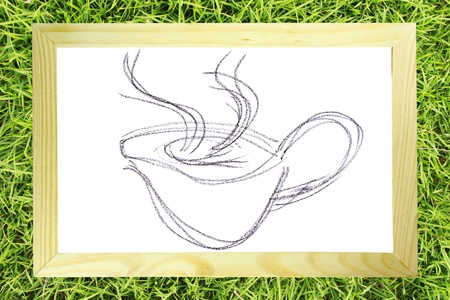 Hand draw sketch of coffee cup on wood frame on grass background