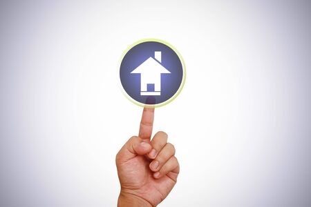 Hand pointing on home iconの写真素材
