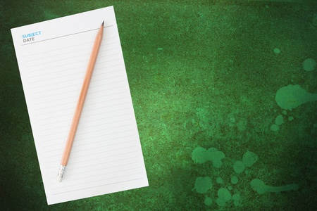 Pencil and blank notepad on grunge backgroundの写真素材