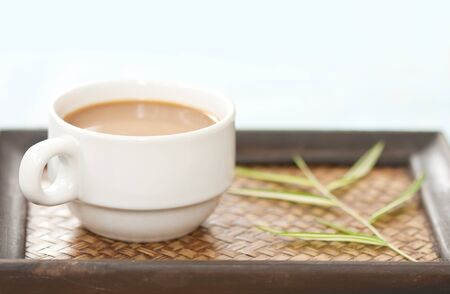 A cup of coffee on wood trayの写真素材