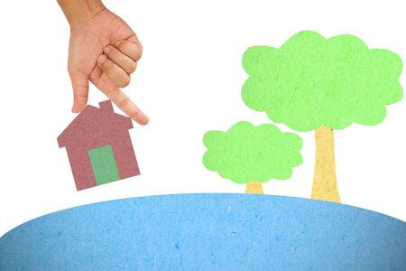 Hand hold house created from color paperの写真素材