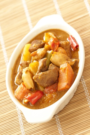 Delicious pork curry with squid on bamboo matの写真素材