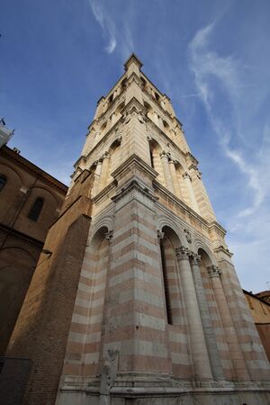 Tall tower at cathedral in Ferrara city, Italyの写真素材