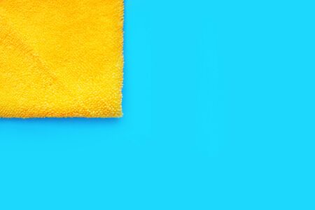 rag and napkin on a blue background. yellow cloth. blue background with space for text. theme of...