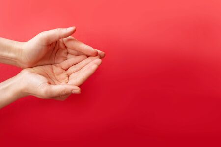 Woman holding decorative heart on red background, top view. Space for textの写真素材