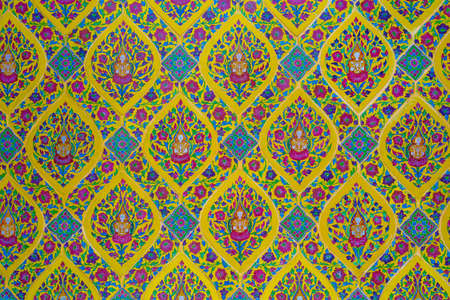 Thai pattern on the wall in a temple in Bangkokの写真素材