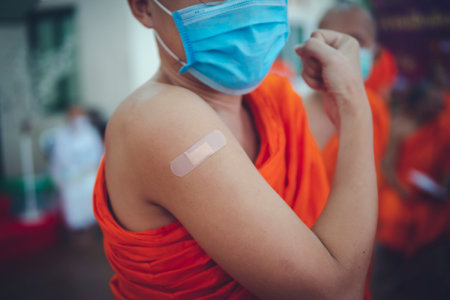 Man showing right arm vaccinated with Covidの写真素材