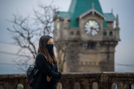 Girl in a black shirt with a clock tower