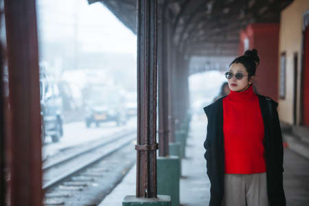 Girl in red shirt in train station