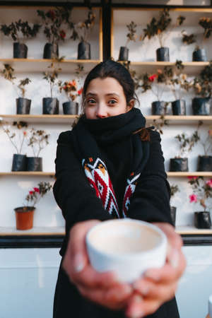 A girl drinking coffee in a coffee shopの写真素材