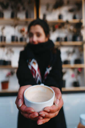 A girl drinking coffee in a coffee shopの写真素材