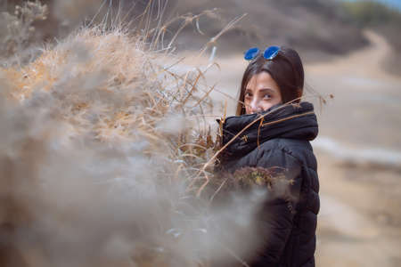 Girl in black forest with a branchの写真素材