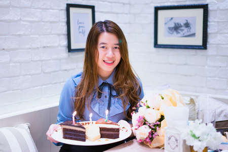 Girl with blue shirt with cakeの写真素材