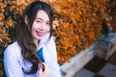 Girl sitting in a chair green tree backgroundの写真素材