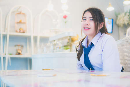 Girl student in a coffee shopの写真素材