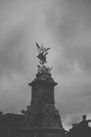 LONDON, UK - OCTOBER 15, 2017: Tourists at Queen Victoria Memorial in front of the Buckingham Palace. The monument was unveiled in 1911.のeditorial素材