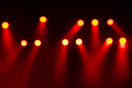 Blurred of Red lights and smoke on stage in the concert