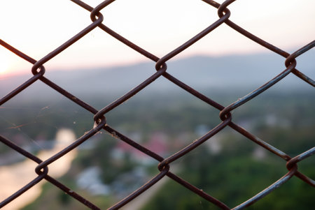 Fence grilles rust texture background,with sunset blur backgroundの写真素材