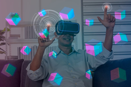Senior man use a VR glasses with 3d cube of future virtual simulation in home office. illustration future technology concept.の写真素材
