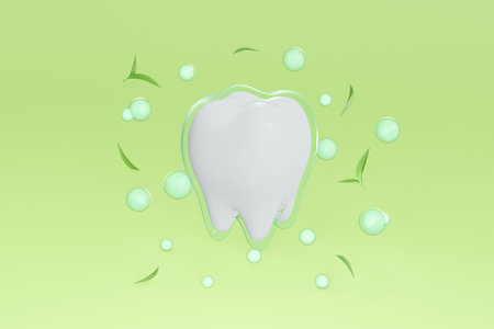3d of white baby tooth or kid teeth with translucent coating, green tea leave and green ball on green studio background. illustration 3d render dental care with natural extracts concept.の写真素材