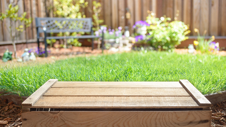 Empty wooden crate with blurred backyard on backgroundの写真素材
