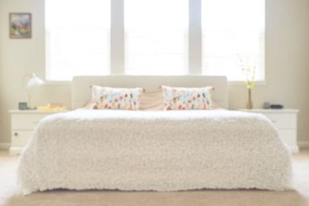 Blurred sunny bedroom in white and yellow colorsの写真素材