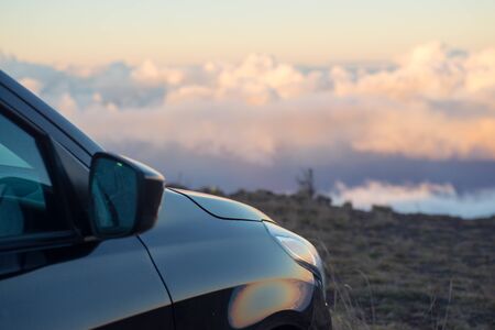 Black car above the clouds at sunset or sunriseの写真素材