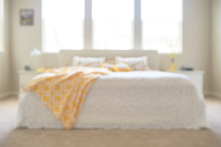 Blurred sunny bedroom in white and yellow colorsの写真素材
