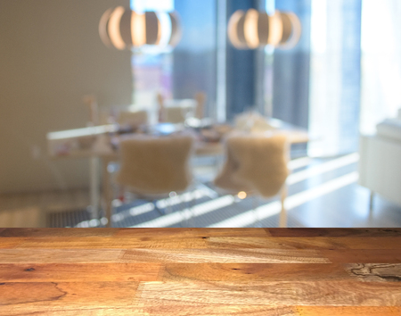 Empty wooden display table top front with blurred kitchen on backgroundの写真素材