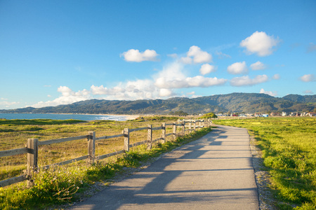Beautiful scenic road on the green bluff above the ocean beachの写真素材