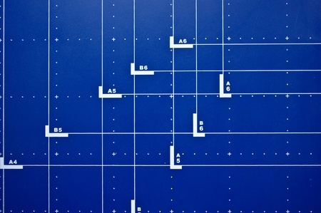 Blue desk background with paper formatsの写真素材