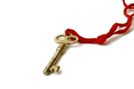 Old Key on a white background with red stringの写真素材