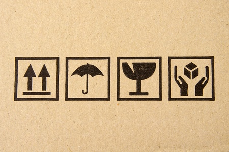 Image close-up of grunge black fragile symbol on cardboard の写真素材