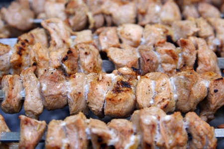 Pieces of marinated pork on barbecueの写真素材
