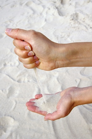 Young woman with sand in hands の写真素材
