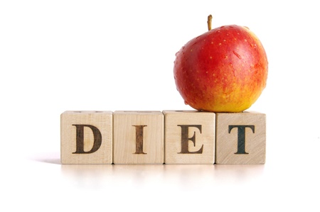 Red apple and cubes with letters in front of a white background - dietの写真素材