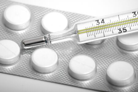 Close-up medical thermometer and pillsの写真素材