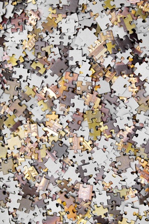 Pieces of puzzle spilled on tableの写真素材