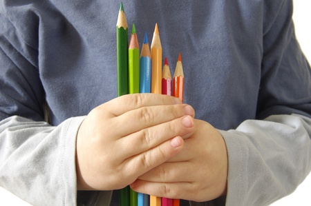Children in hands hold colour pencilsの写真素材