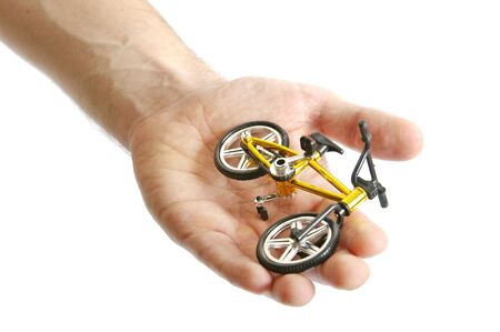 A small toy bicycle in hand の写真素材