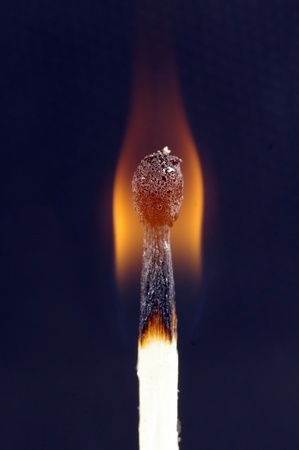 Burning match on a black background の写真素材