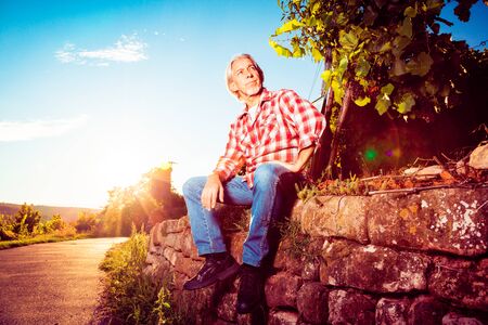 Winemaker Sitting By His Vineyardの写真素材