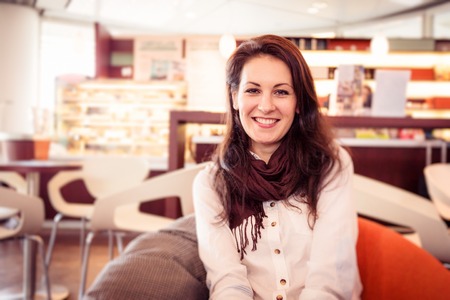 Young Woman Having Coffee In A Cafeの写真素材