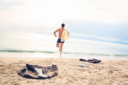 Businessman Running Into The Seaの写真素材