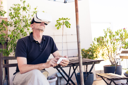 Adult Man Using Vr Goggles On His Balconyの写真素材