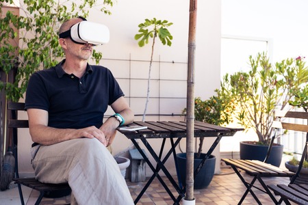 Adult Man Using Vr Goggles On His Balconyの写真素材